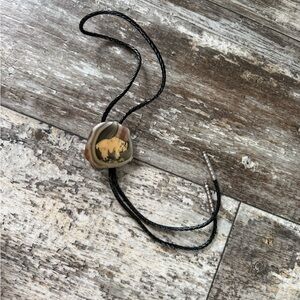 Vintage Montana natural agate stone bolo tie featuring a scenic depiction of yak